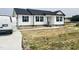 New home with white siding, black shutters, concrete walkway, and freshly poured driveway at 73 Grace Pond Ave, Benson, NC 27504