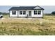Charming home with white siding, black shutters, and a freshly poured concrete walkway at 73 Grace Pond Ave, Benson, NC 27504
