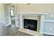 Close up of fireplace with wood mantle and tile surround at 73 Grace Pond Ave, Benson, NC 27504