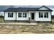 Charming home featuring a black roof, white siding, and complementing black shutters at 73 Grace Pond Ave, Benson, NC 27504