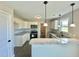 Kitchen with white cabinets, granite countertops, and bar seating at 73 Grace Pond Ave, Benson, NC 27504