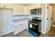 Well-lit kitchen with white cabinets, granite countertops, and stainless steel appliances at 73 Grace Pond Ave, Benson, NC 27504