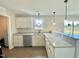 Bright kitchen featuring white cabinets, granite countertops, and stainless steel dishwasher at 73 Grace Pond Ave, Benson, NC 27504