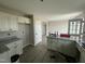 Spacious kitchen has granite countertops, white cabinetry, and stainless steel appliances at 73 Grace Pond Ave, Benson, NC 27504