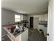 Bright kitchen features granite countertops, white cabinetry, stainless steel dishwasher and fixtures at 73 Grace Pond Ave, Benson, NC 27504