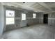 Spacious unfinished living room with natural light and multiple windows at 73 Grace Pond Ave, Benson, NC 27504