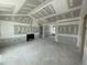 A bare living room with unpainted drywall, an elegant fireplace, and an archway leading to other rooms at 73 Grace Pond Ave, Benson, NC 27504