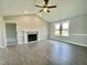 Bright living room with a fireplace, wood floors, ceiling fan, and lots of natural light at 73 Grace Pond Ave, Benson, NC 27504