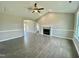 A bright living room with vaulted ceilings, wood flooring, a ceiling fan, and a cozy fireplace at 73 Grace Pond Ave, Benson, NC 27504