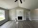 Inviting living room features a vaulted ceiling, modern fireplace, and sleek flooring at 73 Grace Pond Ave, Benson, NC 27504
