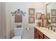 Charming powder room with a decorative mirror, fresh paint, a marble countertop, and a traditional sink at 8005 Crookneck Dr, Angier, NC 27501