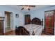 Charming bedroom with blue walls, wood-look floors, ceiling fan, and classic wood furniture at 802 N Fifth St, Mebane, NC 27302