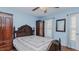 Well-lit bedroom with blue walls, wood-look floors, and classic wood furniture at 802 N Fifth St, Mebane, NC 27302