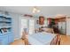 Charming dining area with a blue hutch, table with chairs, and access to the kitchen with stainless steel appliances at 802 N Fifth St, Mebane, NC 27302