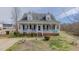 Charming home featuring a welcoming front porch, dormer windows, and a well-manicured lawn at 802 N Fifth St, Mebane, NC 27302
