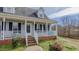 Inviting front porch with white railing and brick steps, perfect for enjoying outdoor relaxation at 802 N Fifth St, Mebane, NC 27302