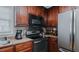Kitchen featuring stainless steel appliances and dark wood cabinetry at 802 N Fifth St, Mebane, NC 27302