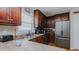 Functional kitchen with stainless steel appliances, dark wood cabinets, and ample counter space at 802 N Fifth St, Mebane, NC 27302