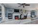 Spacious living room with hardwood floors, a gray sectional sofa, fireplace, and access to the dining area at 802 N Fifth St, Mebane, NC 27302
