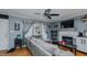 Comfortable living room with hardwood floors, a gray sectional sofa, fireplace, and large windows for natural light at 802 N Fifth St, Mebane, NC 27302