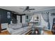 Comfortable living room featuring hardwood floors, a gray sectional sofa, and a black accent wall at 802 N Fifth St, Mebane, NC 27302