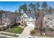 Aerial view of a landscaped property with mature trees, circular driveway, and attractive home exterior at 803 Landuff Ct, Cary, NC 27519