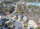 Aerial view of a neighborhood featuring mature trees, manicured lawns, and community areas at 803 Landuff Ct, Cary, NC 27519