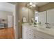 Bathroom featuring double sink vanity with white cabinets, framed mirror, and decorative lighting creating a welcoming space at 803 Landuff Ct, Cary, NC 27519