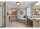 Relaxing bathroom featuring dual vanities, soaking tub, and decorative accents at 803 Landuff Ct, Cary, NC 27519