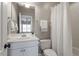 Bright bathroom featuring white vanity, and a shower with a white curtain, providing a clean, fresh aesthetic at 803 Landuff Ct, Cary, NC 27519