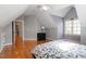 Bedroom with slanted ceilings, hardwood floors, and plenty of natural light at 803 Landuff Ct, Cary, NC 27519