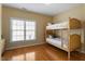 Bedroom with wood bunk beds and a large window for natural light, perfect for a shared ' room at 803 Landuff Ct, Cary, NC 27519