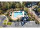 Aerial shot of a community pool with lounge chairs, umbrellas, and a clubhouse at 803 Landuff Ct, Cary, NC 27519