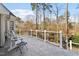 View of a relaxing outdoor deck with white railings, tile flooring, and comfortable seating overlooking the backyard at 803 Landuff Ct, Cary, NC 27519