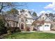 Charming home with a well-manicured lawn, stone accents, and a welcoming front entrance and two-car garage at 803 Landuff Ct, Cary, NC 27519