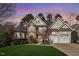 Charming two-story home featuring a stone and siding facade, well-manicured lawn, and two-car garage at 803 Landuff Ct, Cary, NC 27519