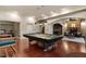 Spacious game room with a pool table, stone fireplace, and comfortable seating area at 803 Landuff Ct, Cary, NC 27519