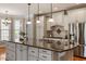 Stylish kitchen with white cabinetry, a large island, stainless steel appliances, and pendant lighting at 803 Landuff Ct, Cary, NC 27519