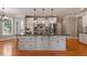 Gourmet kitchen featuring a large center island, custom cabinetry, and modern appliances at 803 Landuff Ct, Cary, NC 27519