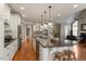 Open-concept kitchen with a large island, seating, and stainless steel appliances at 803 Landuff Ct, Cary, NC 27519