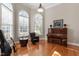 Cozy living room with large windows and a piano at 803 Landuff Ct, Cary, NC 27519