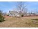Backyard view featuring a treed perimeter, lawn and patio with home beyond at 100 Watkins Farm Rd, Rolesville, NC 27571