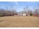 Large backyard featuring a treed perimeter, lawn and patio with home beyond at 100 Watkins Farm Rd, Rolesville, NC 27571