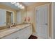 A double sink bathroom with a large mirror, granite countertop and white cabinetry at 100 Watkins Farm Rd, Rolesville, NC 27571