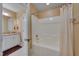 Bathroom view showing shower/tub combo, granite vanity and framed mirror at 100 Watkins Farm Rd, Rolesville, NC 27571