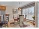 Cozy dining area with a round table, chandelier, and natural light from large windows at 100 Watkins Farm Rd, Rolesville, NC 27571