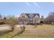 Traditional home featuring a two-car garage, complemented by a spacious front yard and mature trees at 100 Watkins Farm Rd, Rolesville, NC 27571