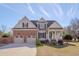 Charming two-story home with a brick and beige facade, complemented by a well-manicured lawn at 100 Watkins Farm Rd, Rolesville, NC 27571