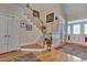 Warm and inviting foyer featuring hardwood floors, a staircase, and a view of the front entrance at 100 Watkins Farm Rd, Rolesville, NC 27571