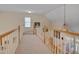 A view of the carpeted hallway on the second floor with light colored walls at 100 Watkins Farm Rd, Rolesville, NC 27571